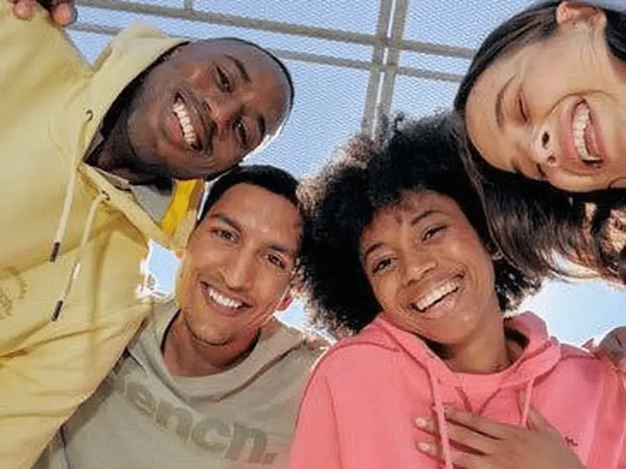 Four friends laughing together